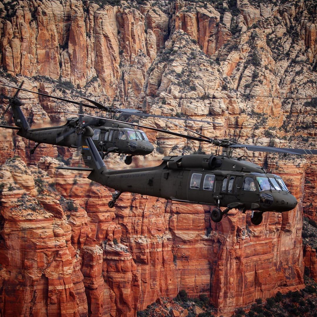 Arizona Army aviation aircraft flying against red rock canyon walls